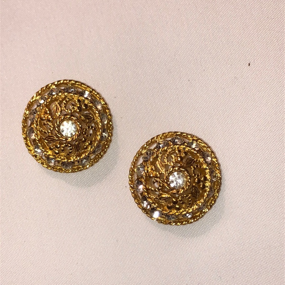 Pair of vintage gold-tone filigree button earrings with center rhinestone